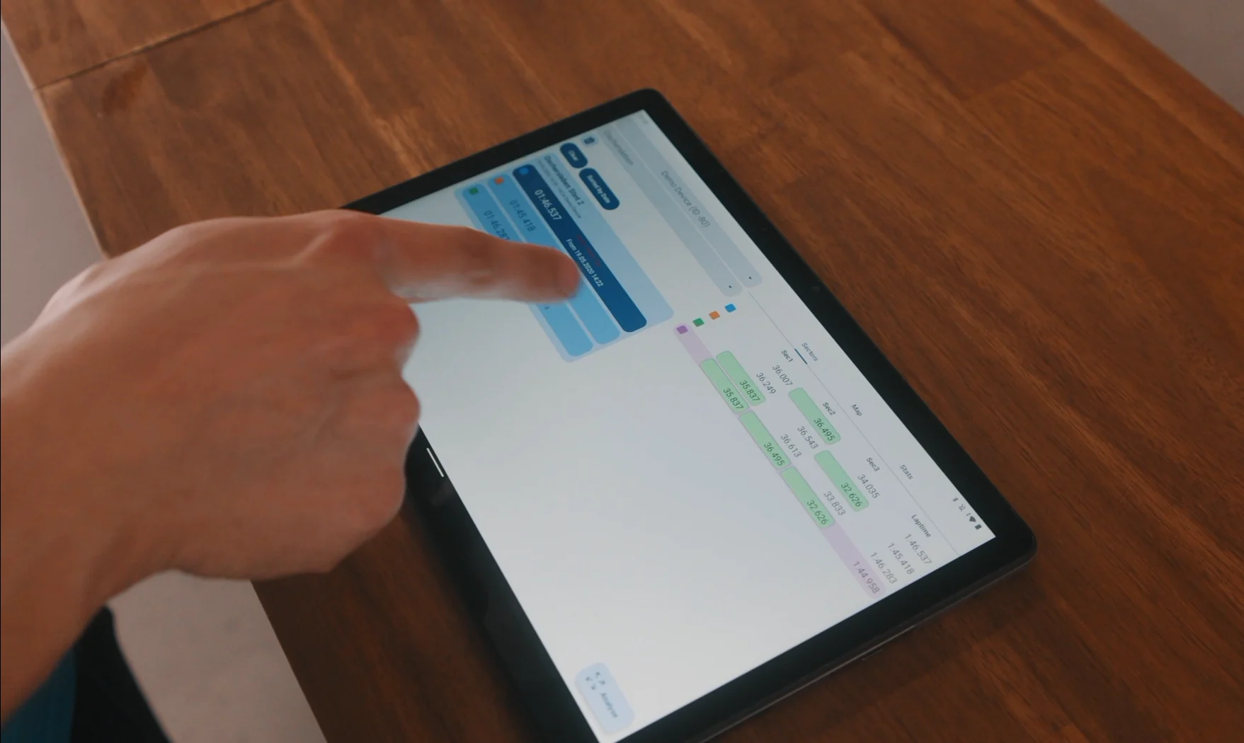 Trackside engineer reviewing lap data on a tablet
